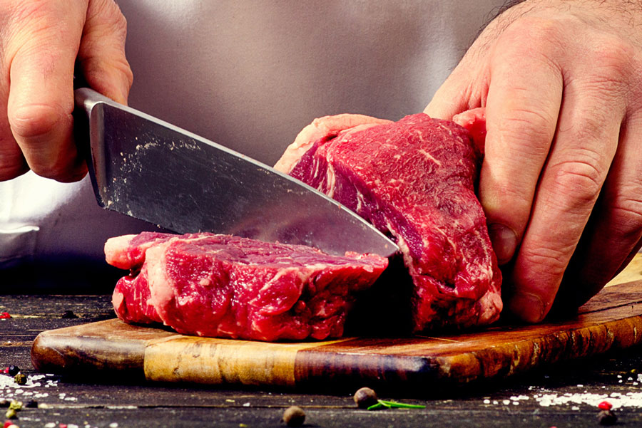 Chef cutting meat